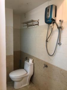 a bathroom with a toilet and a shower at Sea Urchin Homestay in Phan Rang