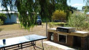 a grill and a picnic table with a truck in a park at Cottage 53 - Topspot Cottages in Jurien Bay +4 photos