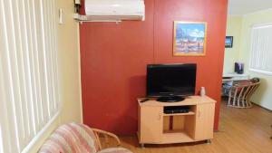 a living room with a tv on a small table at Cottage 53 - Topspot Cottages in Jurien Bay