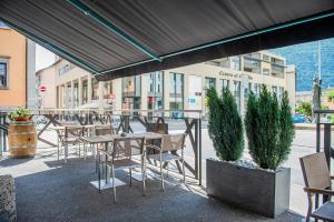 a group of tables and chairs on a patio at Garni Moderno in Bellinzona