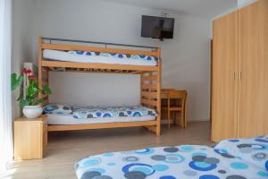 Rúm í herbergi á Garni Moderno