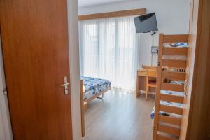 Rúm í herbergi á Garni Moderno