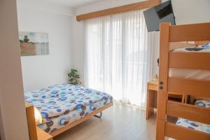 Rúm í herbergi á Garni Moderno