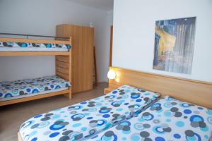 Rúm í herbergi á Garni Moderno