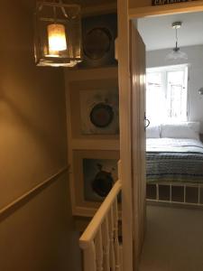 a room with a staircase with a bed and a window at 9 Melinda Cottage in Cromer