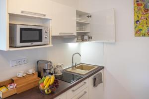 a small kitchen with a sink and a microwave at Calma in Luhačovice