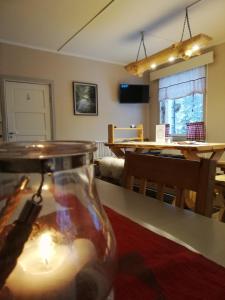 a room with a candle in a vase on a table at Karkausmäen Kammari in Kinnula +50 photos