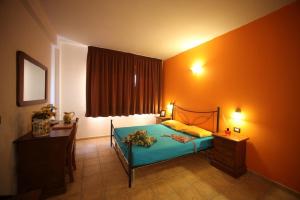 a bedroom with a bed and a desk and a window at Agriturismo AgriCostella Vieste, Piscina e Parcheggio in Vieste +54 photos