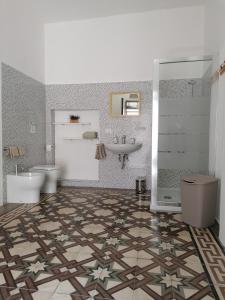 a bathroom with two toilets and a sink at Da Pippi e Gesuina in Matino +43 photos