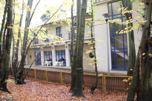 an exterior view of a house with trees at Hotel Leśny in Sopot