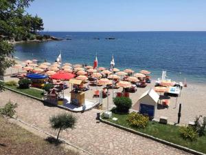 a group of umbrellas and chairs on a beach at Marina's apartment Ogliastra in Lotzorai