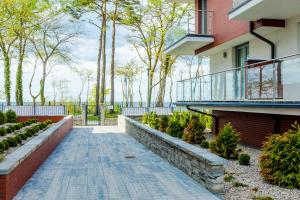 Vonkajšia záhrada v ubytovaní Resort Apartamenty Klifowa Rewal 32
