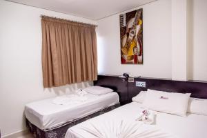 Säng eller sängar i ett rum på Bougainville Barreiras