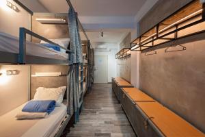 a hallway with bunk beds in a dorm room at Bedbox Hostel in Athens