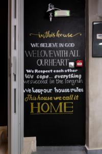 Une porte avec un panneau indiquant que nous appelons cette maison. dans l'établissement Bedbox Hostel, à Athènes