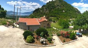 a house with a garden in front of a mountain at Albomi in Kotor