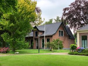 a house with a green lawn in front of it at B&B Pastorie Jelsum in Jelsum