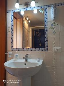 a bathroom with a sink and a mirror at camera azzurra San Vito Lo Capo in San Vito lo Capo