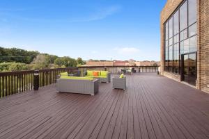 a deck with couches and chairs on a building at Holiday Inn Chicago Nw Crystal Lk Conv Ctr, an IHG Hotel in Crystal Lake