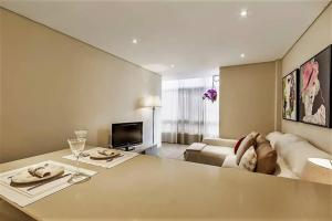 a living room with a table and a couch at InLoveApartments - City Center With Charm in Lisbon