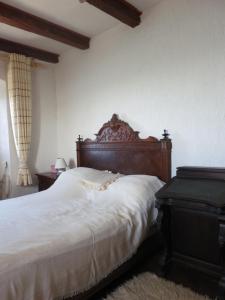 a bedroom with a large bed with a wooden headboard at Ustrine view in Ustrine