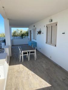 a dining room with a table and chairs on a patio at Vill’Aura in Vieste