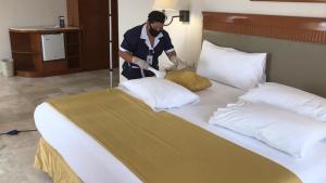 Postel nebo postele na pokoji v ubytování Hotel Olmeca Plaza