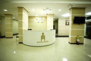 a lobby with a stand in the middle of a building at Alpha Suites Hotel in Salalah