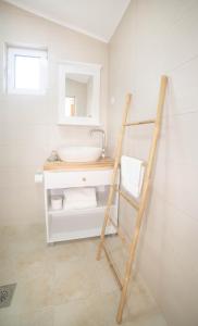 a bathroom with a ladder next to a sink at Plamenatz studio apartments in Virpazar +66 photos