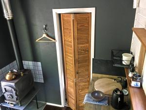 a kitchen with a wooden door in a room at Inkilas in Sidabrinės