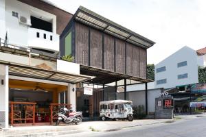 an old car parked in front of a building at The Album Loft in Patong Beach
