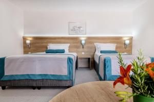 Postel nebo postele na pokoji v ubytování Hotel Porat