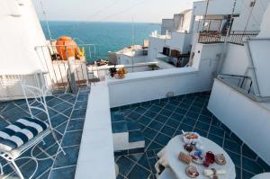a balcony with a table and chairs on a cruise ship at Anna's Rose Holiday Home in Monopoli
