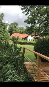 a wooden staircase leading to a garden with a house at Agroturystyka Marzena in Kętrzyn