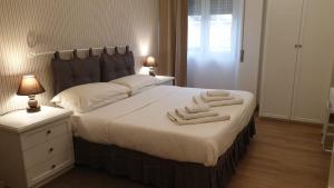 a bedroom with a bed with two towels on it at B&B AMAVERONA in Verona