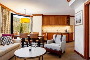 a living room filled with furniture and a table at Resort at Squaw Creek, a Destination by Hyatt Residence in Olympic Valley