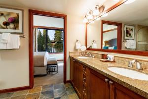 
a bathroom with a sink, mirror, and toilet at Resort at Squaw Creek, a Destination by Hyatt Residence in Olympic Valley
