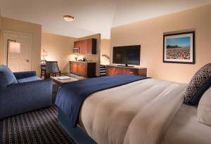 a hotel room with a large bed and a couch at Bristol Harbor Inn in Bristol