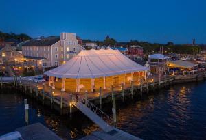 a pier with a tent on the water at night at Bristol Harbor Inn in Bristol