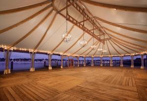 a large tent with a wooden floor and chandeliers at Bristol Harbor Inn in Bristol