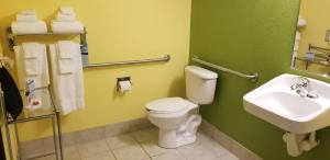 a bathroom with a toilet and a sink at Microtel Inn & Suites by Wyndham Delphos in Delphos