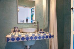 a bathroom with a sink and a mirror at Riad Dar Aida in Marrakech