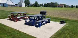 a picnic table and two benches in a field at Microtel Inn & Suites by Wyndham Delphos in Delphos