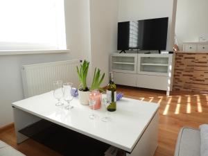 a living room with a white table with wine glasses at Bajka Anity in Wilkasy