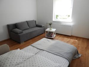 a living room with a bed and a couch at Bajka Anity in Wilkasy