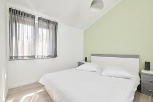 Postel nebo postele na pokoji v ubytování Villa Dvori
