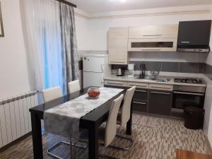a kitchen with a table and chairs in a room at Guesthouse Blazenka Hodak in Seliste Dreznicko