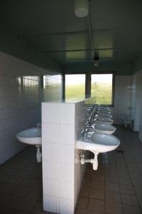 a row of sinks in a public bathroom at Kemp Rumcajs in Jičín