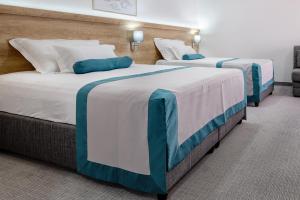 Postel nebo postele na pokoji v ubytování Hotel Porat