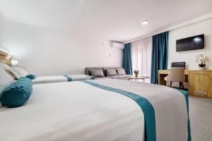 Postel nebo postele na pokoji v ubytování Hotel Porat